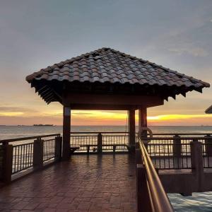 a gazebo on a pier with the ocean at Alpine LXPD Water Chalet in Port Dickson