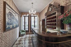 a home office with a desk and a chandelier at Antica Locanda al Gambero in Venice