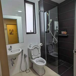 a bathroom with a shower and a toilet and a sink at ALOCASIA Geniehome 3BR Free Wifi @ Utropolis Shah Alam in Shah Alam