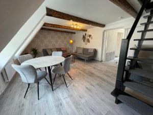 a dining room with a table and chairs and a couch at Ferienwohnung Goslar am Marktplatz A4 in Goslar