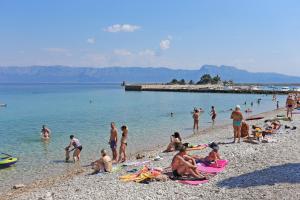 a group of people on a beach in the water at Apartments by the sea Trpanj, Peljesac - 16004 in Trpanj