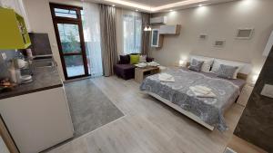 a bedroom with a bed and a living room at Sunrise City A1, Sarafovo in Burgas City