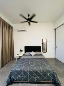 a bedroom with a bed with a ceiling fan at EmpiStudio @ Empire Damansara in Petaling Jaya