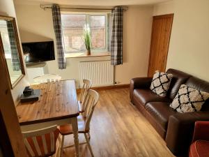 a living room with a table and a couch at 2 Mill Street in Penrith