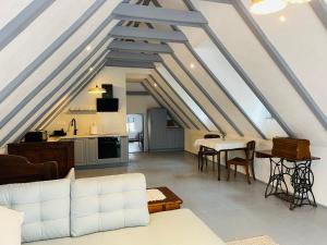 a living room with a white couch and a table at Casa Boierului Comanici in Veneţia de Jos