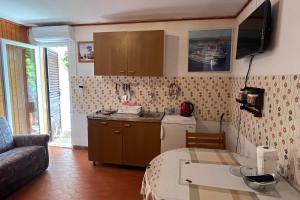 a kitchen and living room with a couch and a table at Apartments by the sea Racisce - Korcula - 4359 in Račišće