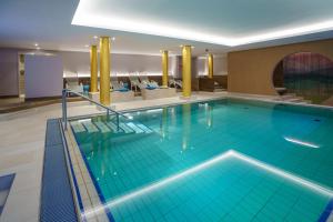 a large swimming pool in a hotel room at AMBER HOTEL Bavaria in Bad Reichenhall