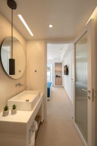 a bathroom with a sink and a mirror at KAMEO, Antiparos in Antiparos