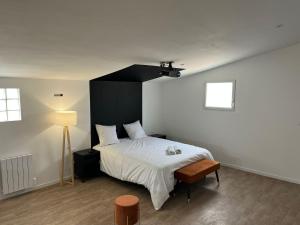 a bedroom with a large bed with a black headboard at NG SuiteHome - Queven - Balnéo - Netflix - Wifi in Quéven