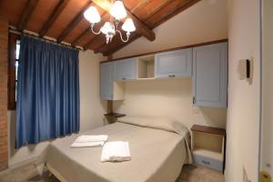 a bedroom with a bed with two towels on it at Villa Bolgherello in Marina di Bibbona