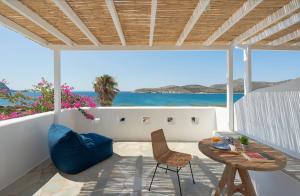 a patio with a table and chairs and the ocean at KAMEO, Antiparos in Antiparos