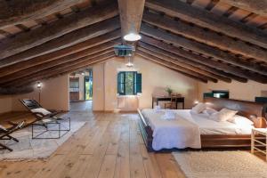 - une grande chambre avec un grand lit et du parquet dans l'établissement Flateli Mas Llop, à Sant Climent de Peralta