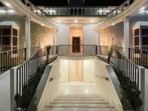 a staircase leading up to a building with lights at DISCOVERY GUEST HOUSE (CHALET) - in SUR in Aţ Ţawīyān
