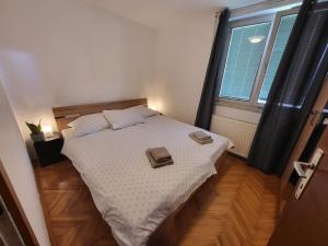 a bedroom with a bed with two towels on it at Sava river house - apartments in Bled