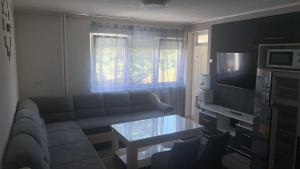 a living room with a couch and a table at Stan na dan Banovići in Banovići