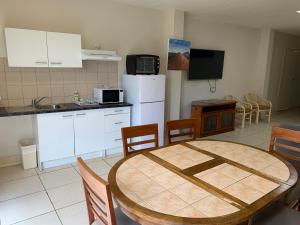 a kitchen and dining room with a table and chairs at Cairns City Sheridan Motel in Cairns