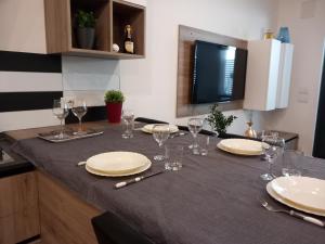 a table with plates and wine glasses on it at Rome 66 apartments in Rome