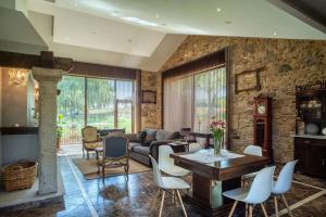 a living room with a couch and a table and chairs at CASA DO LEAL SILVER WAY in Silleda