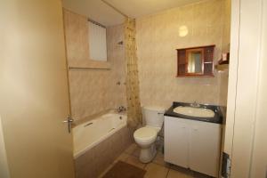 a bathroom with a toilet and a sink and a bath tub at Boulevard 105 in Margate