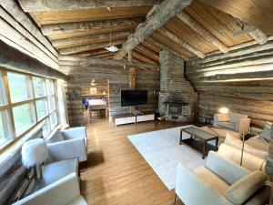 a large living room with a stone wall at Kelo / Lapland, Saariselkä in Saariselka