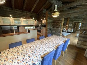 a dining room with a table and blue chairs at Kelo / Lapland, Saariselkä in Saariselka