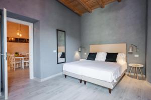 A bed or beds in a room at Five Stars Sicily by Ortigia Apartments