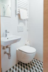 een witte badkamer met een toilet en een wastafel bij Arche Siedlisko Rogacze 65 in Milejczyce