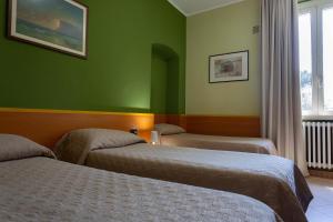 Postel nebo postele na pokoji v ubytování Hotel La Quercia