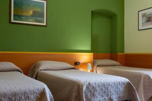 Postel nebo postele na pokoji v ubytování Hotel La Quercia