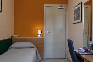 Postel nebo postele na pokoji v ubytování Hotel La Quercia