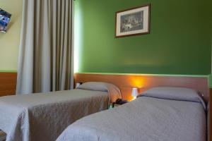Postel nebo postele na pokoji v ubytování Hotel La Quercia