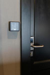 a clock on the side of a door in an elevator at Numa Prague Root in Prague