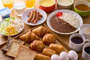 a table topped with different types of food and drinks at Hotel Axia Inn Sapporo Susukino in Sapporo