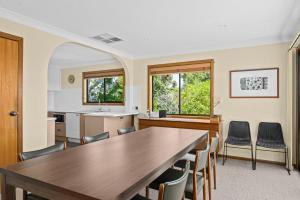 a kitchen and dining room with a table and chairs at Port of Call - Port Willunga - C21 SouthCoast Holidays in Port Willunga