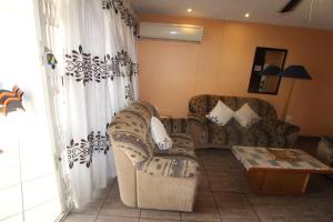 a living room with a couch and a table at Boulevard 114 in Margate