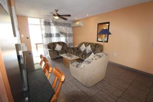 a living room with two couches and a table at Boulevard 114 in Margate