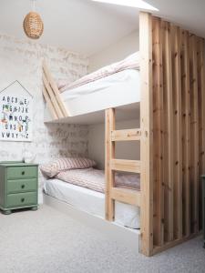 a bedroom with a bunk bed with a ladder at Coorie Away - Kirkcudbright in Kirkcudbright