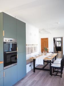 a kitchen with a table and a dining room at Coorie Away - Kirkcudbright in Kirkcudbright +43 photos