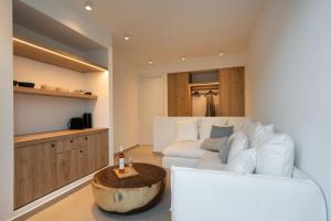 a living room with a white couch and a table at KAMEO, Antiparos in Antiparos