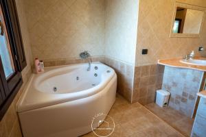 a bathroom with a tub and a sink at La casa in Terralba +13 photos