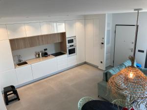a living room with a couch and a kitchen at Casa Flamencos in Rojales