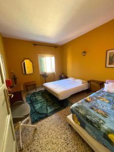 a bedroom with two beds and a window at Borgo Prino in Imperia