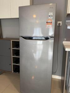 a stainless steel refrigerator in a kitchen at 【NETFLIX】Suasana Suites,Nxt to CIQ【PoolGym&WIFI】 in Johor Bahru