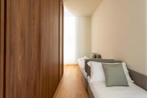 ELICAL Exclusive Private Suites客房内的一张或多张床位