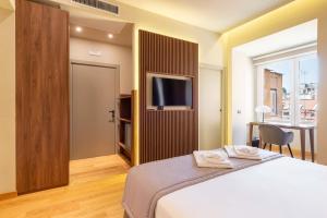 ELICAL Exclusive Private Suites客房内的一张或多张床位