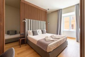 ELICAL Exclusive Private Suites客房内的一张或多张床位
