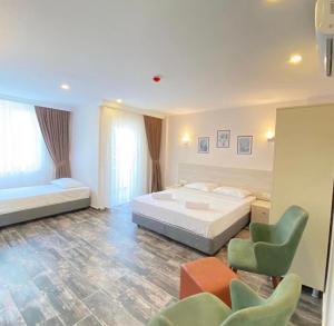 a large bedroom with a bed and a chair at Dream Town Hotel&Restaurant in Kemer