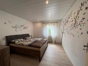 1 dormitorio con 1 cama en una habitación con ventana en Ferienwohnung "Auszeit" mit Garten, en Riedlhütte