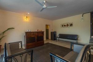 a living room with a ceiling fan and a couch at SaffronStays Blue Infinitum, Pawna in Lonavala