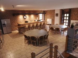 a room with two tables and chairs and a kitchen at Eichenthal Ferienhaus in Geilenkirchen